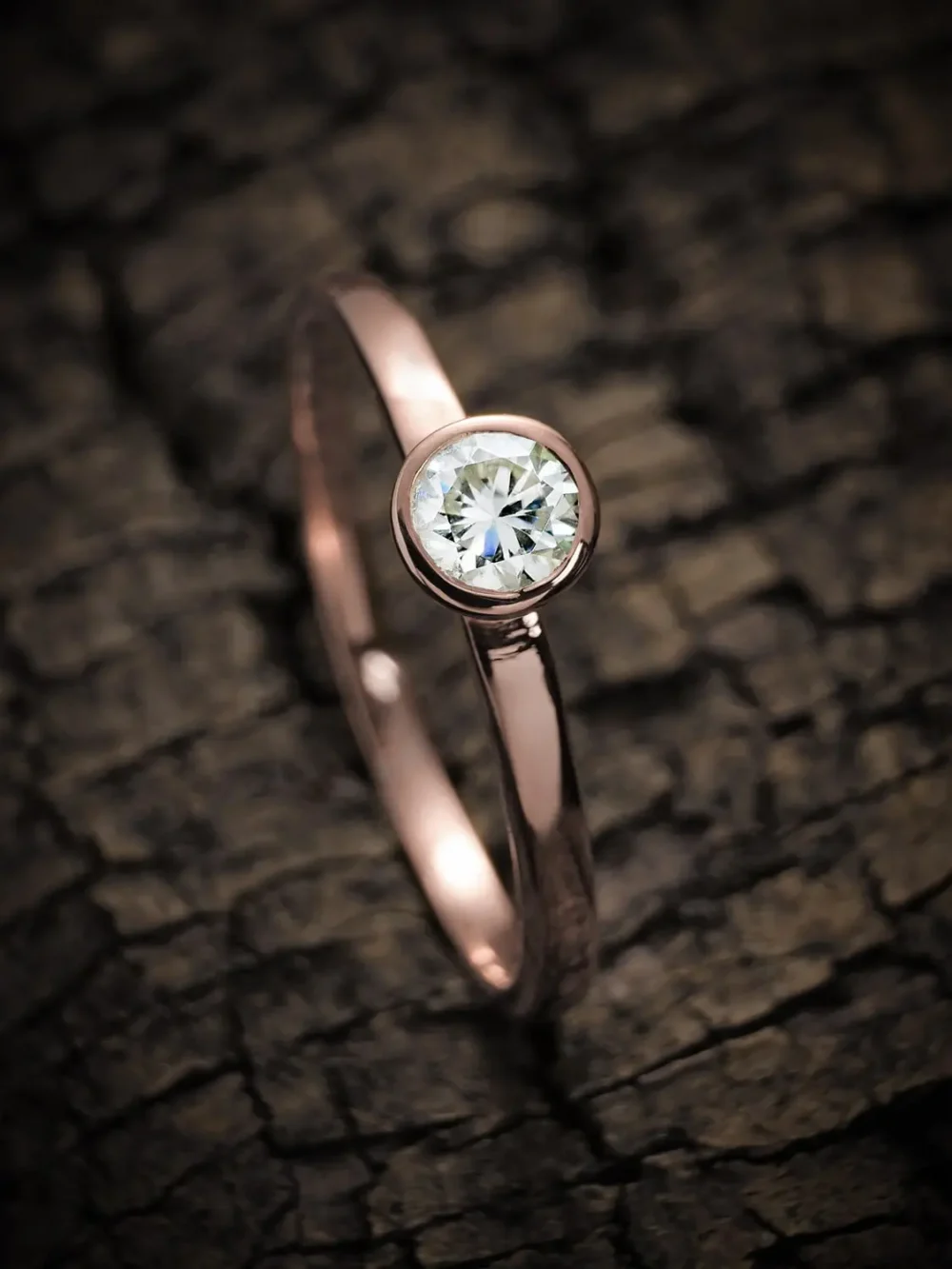 Minimalist moissanite diamond ring on a rose gold band