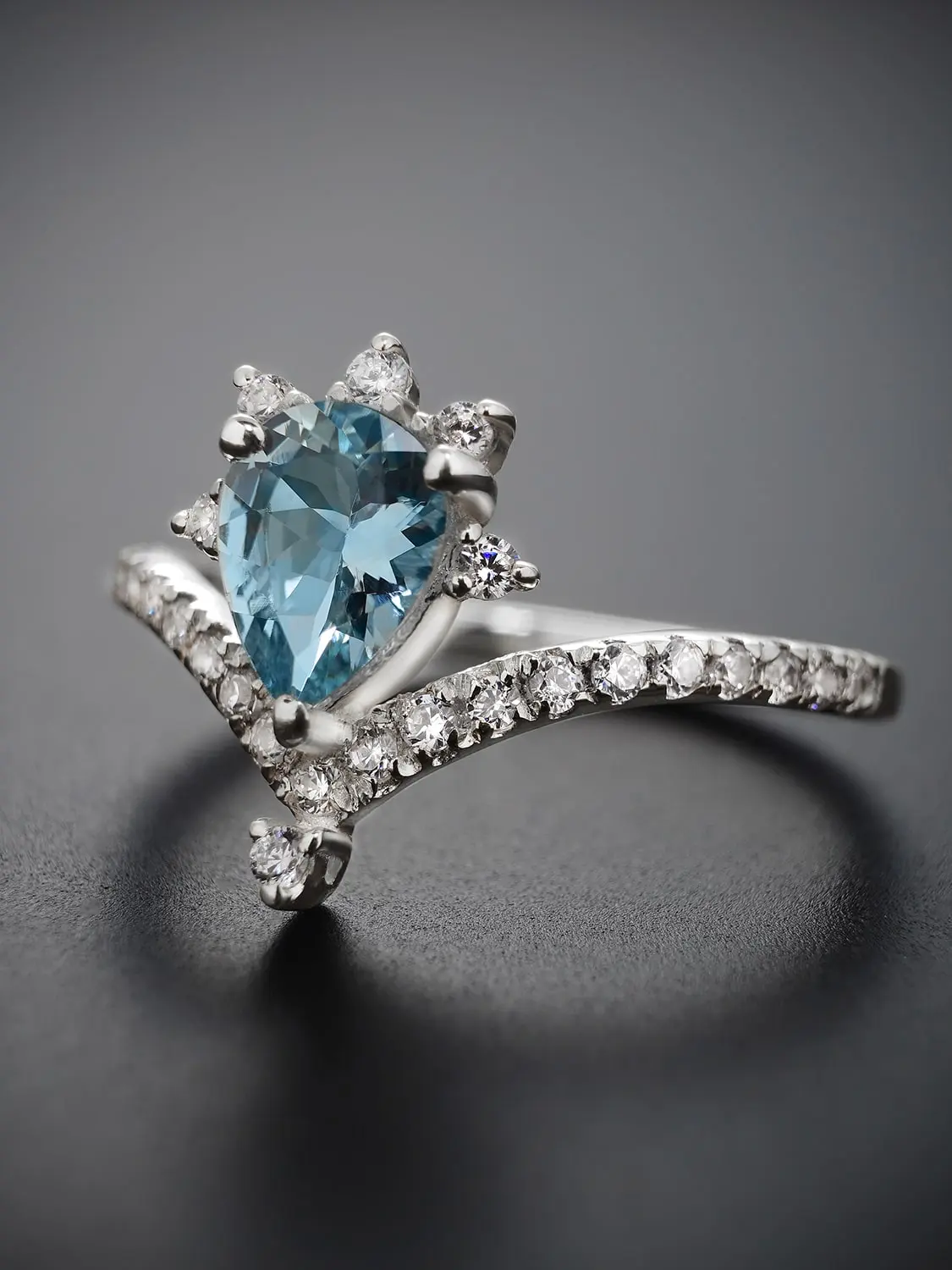 Stellar glow blue topaz ring showcased against a dark background