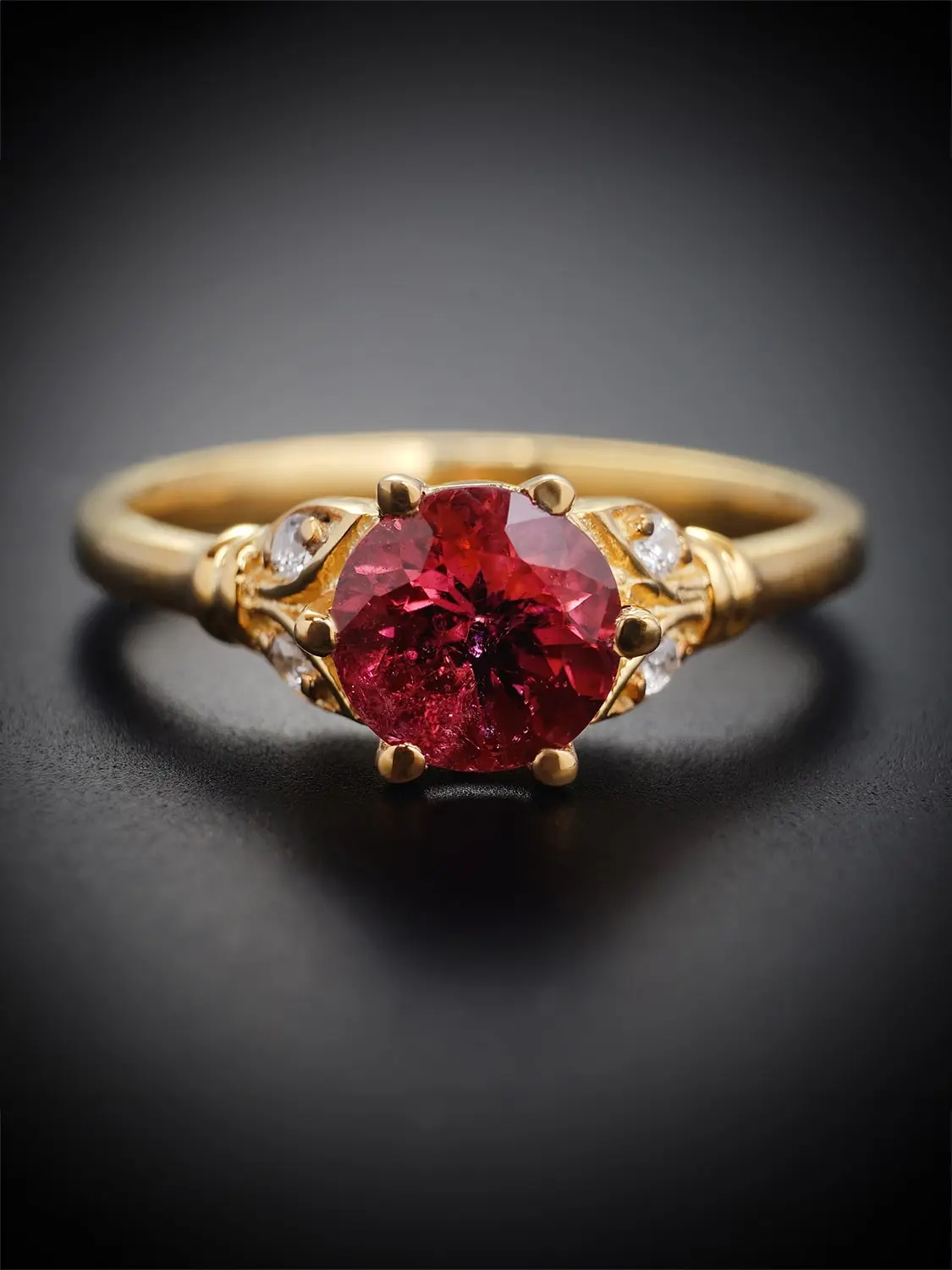 Close-up of rubellite tourmaline ring in gold setting