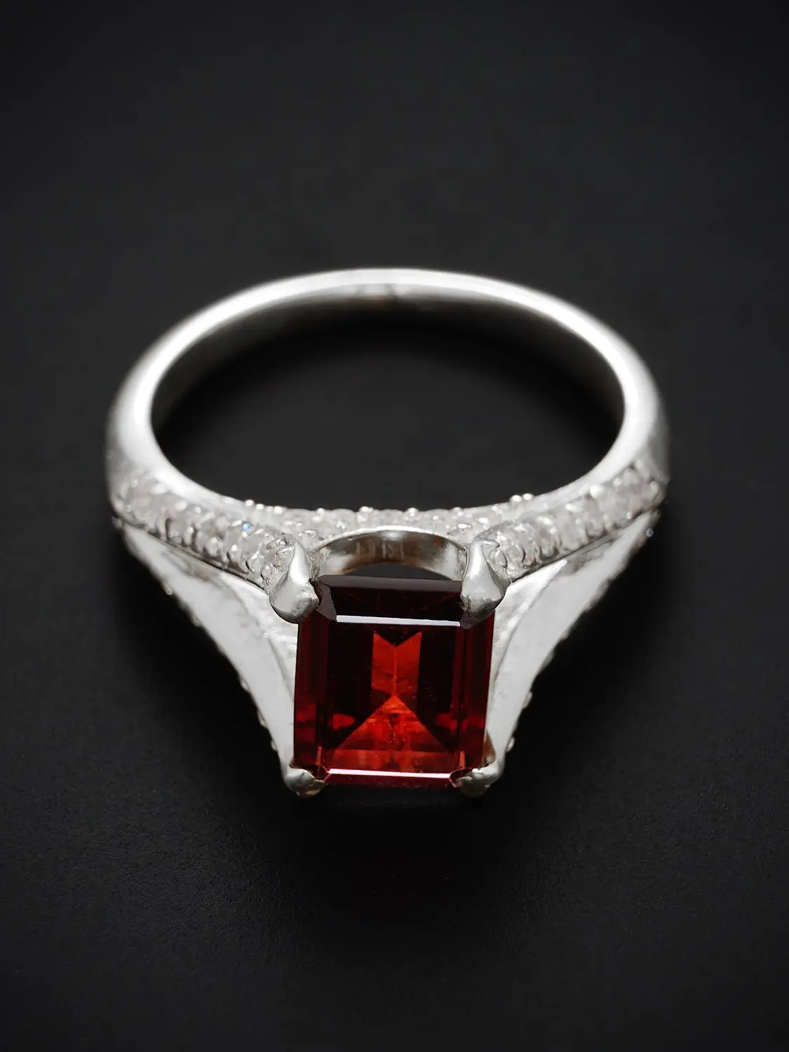 Luxurious red garnet and moissanite diamond ring in split shank setting