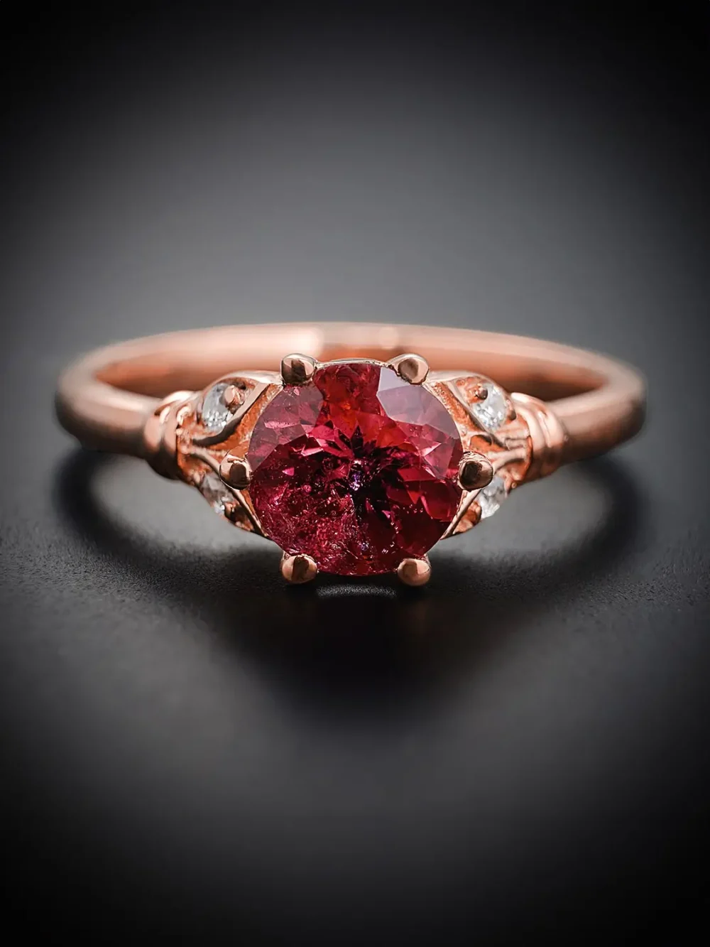Front view of rose gold rubellite tourmaline ring with moissanite accents