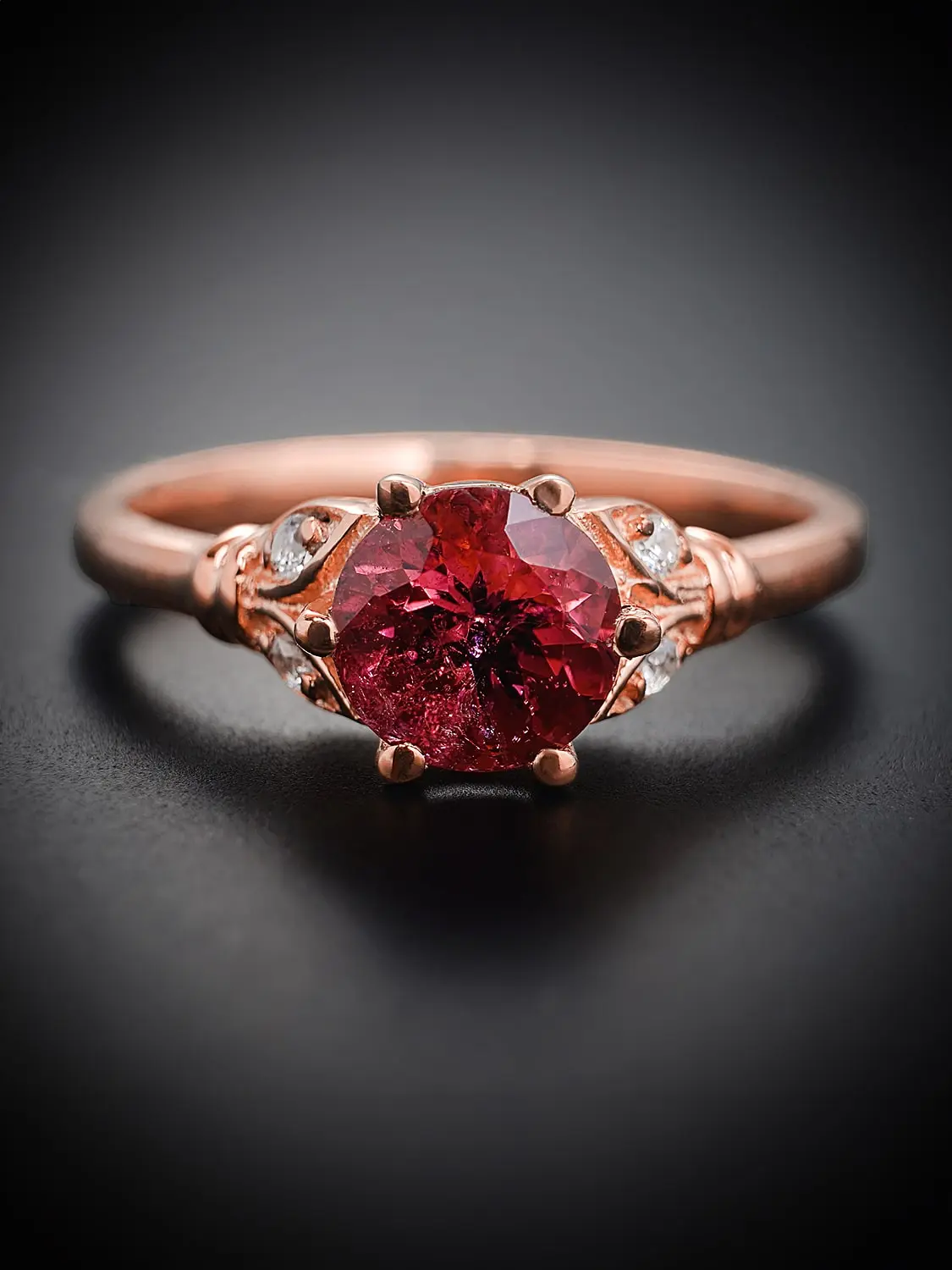 Front view of rose gold rubellite tourmaline ring with moissanite accents