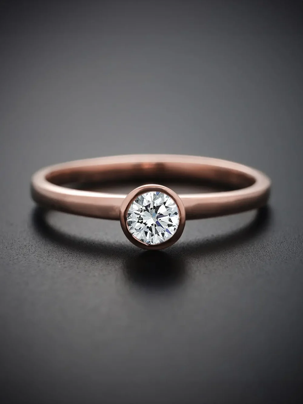 Minimalist moissanite diamond ring on a rose gold band