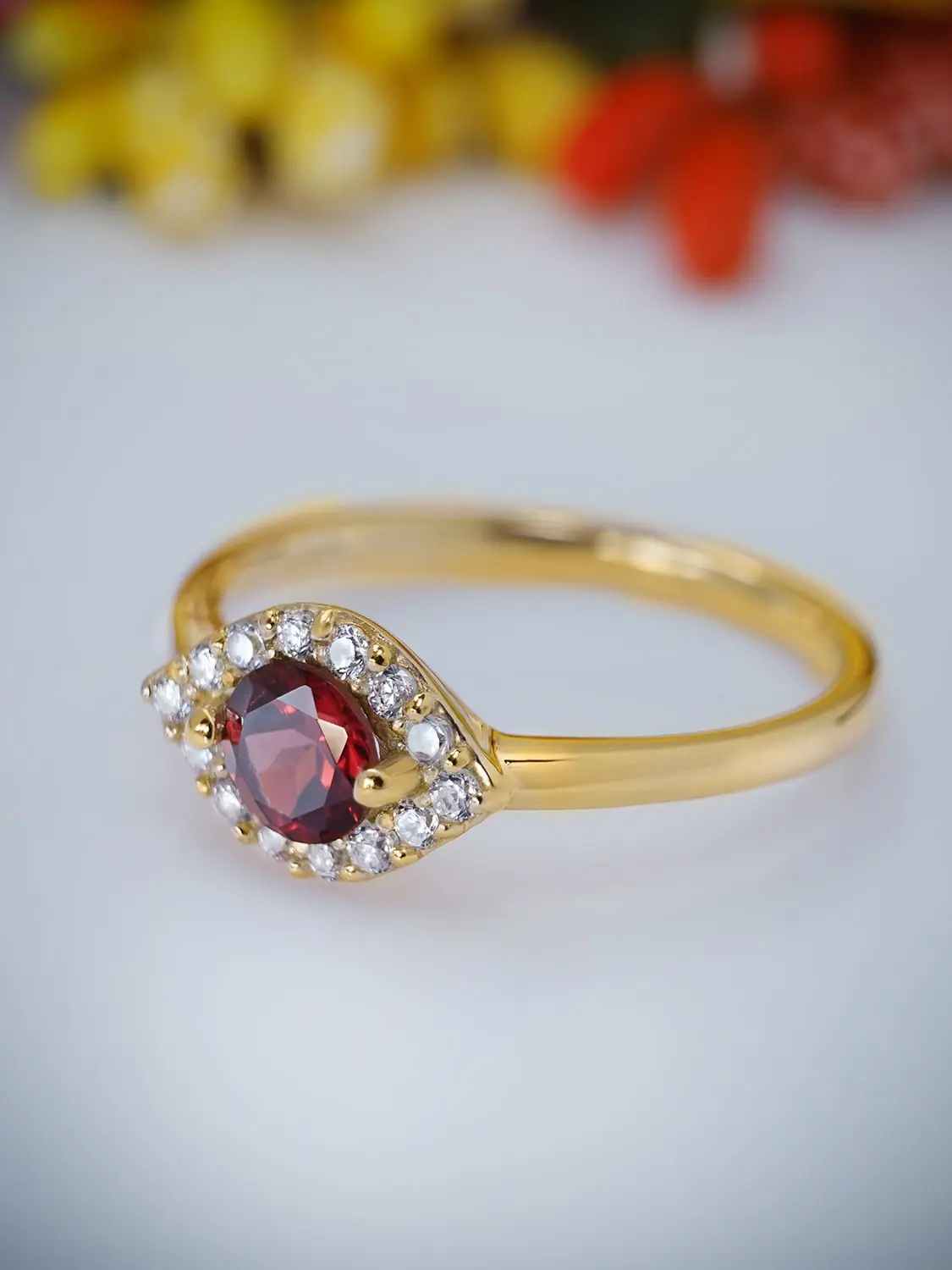 Elegant red garnet and moissanite diamond ring in gold