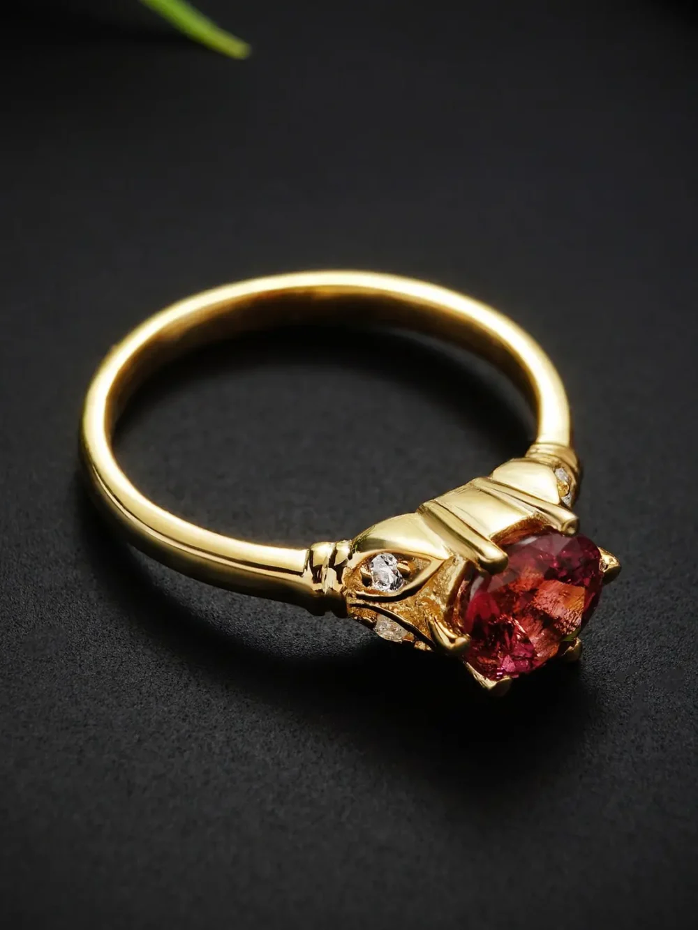 Close-up of rubellite tourmaline ring in gold setting