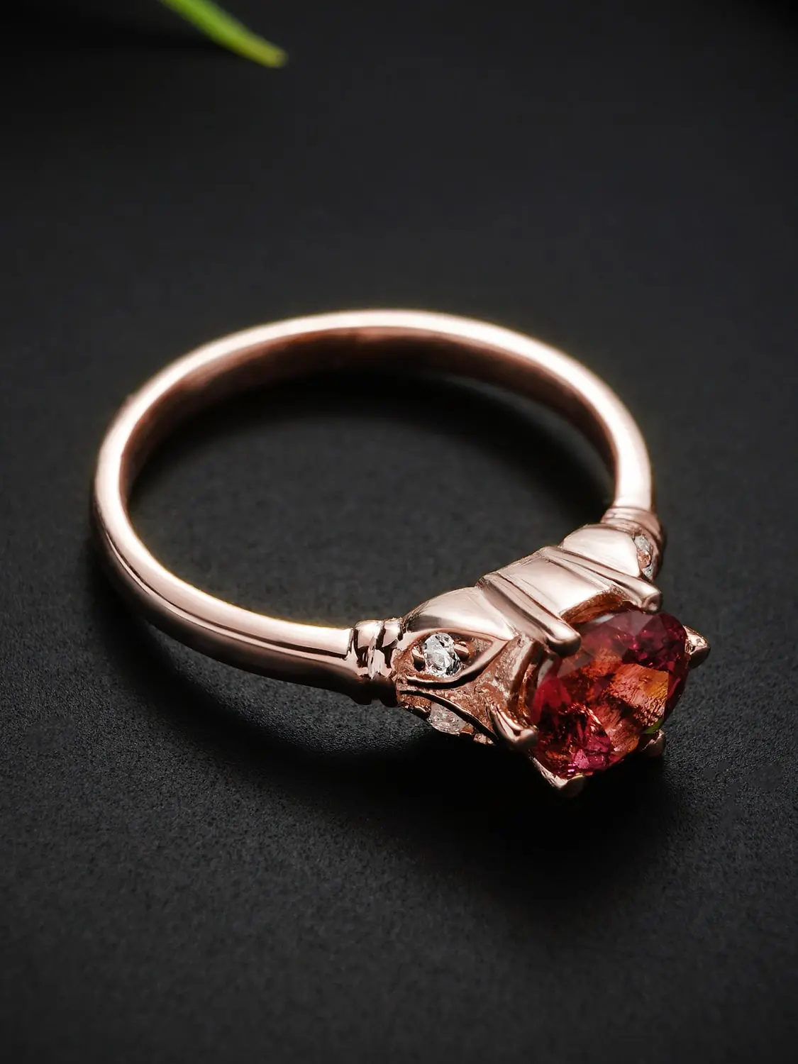 Side view of rose gold rubellite tourmaline ring with moissanite accents