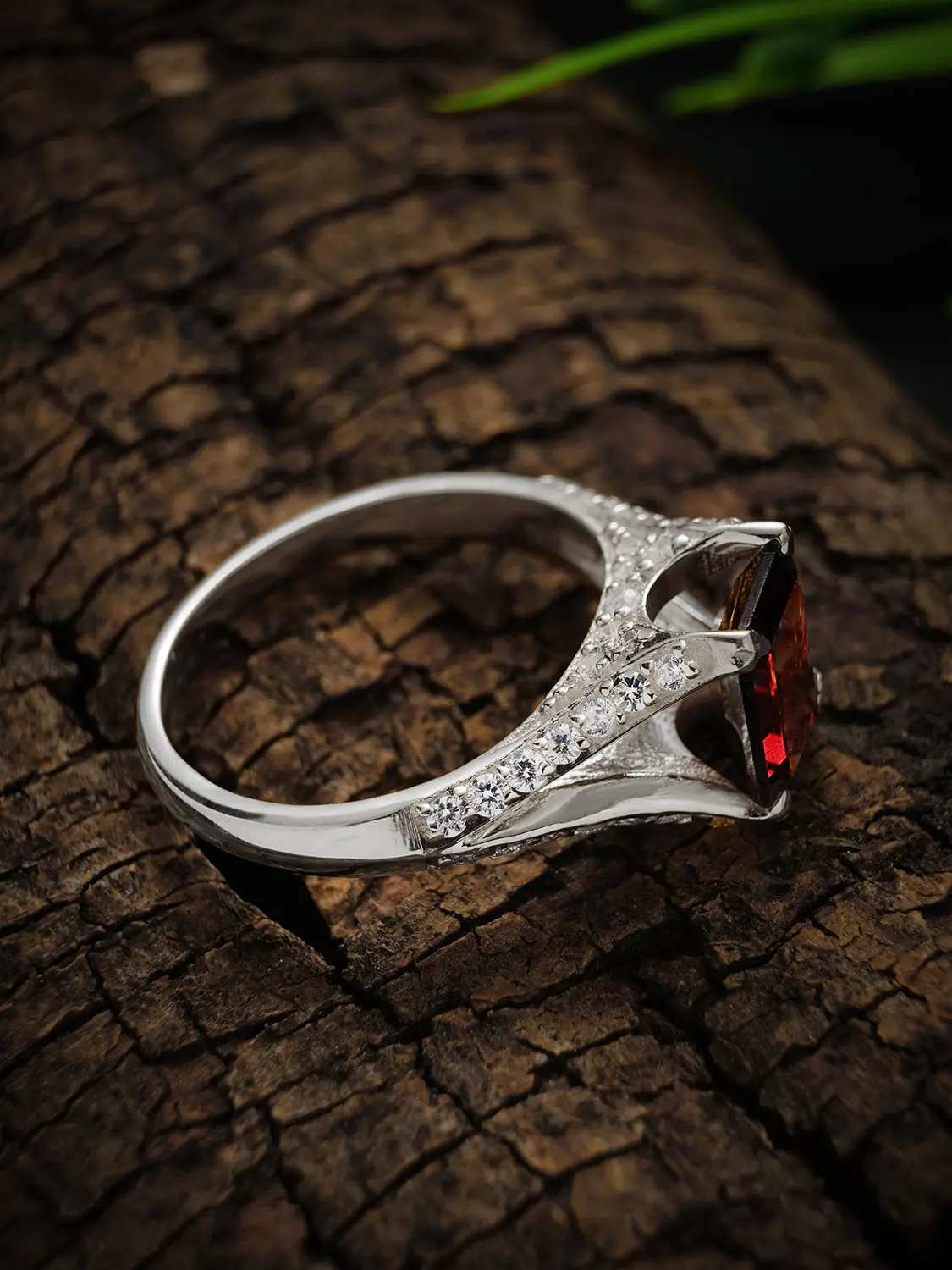 Crimson majesty garnet ring on a wooden backdrop
