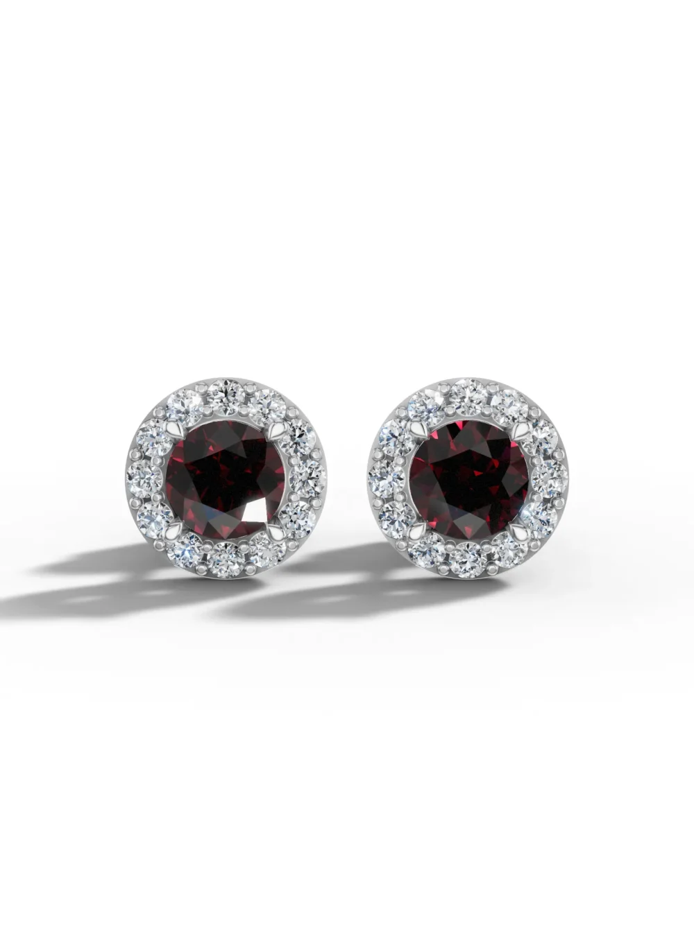 Pair of garnet halo stud earrings with moissanite diamonds in white gold plated sterling silver