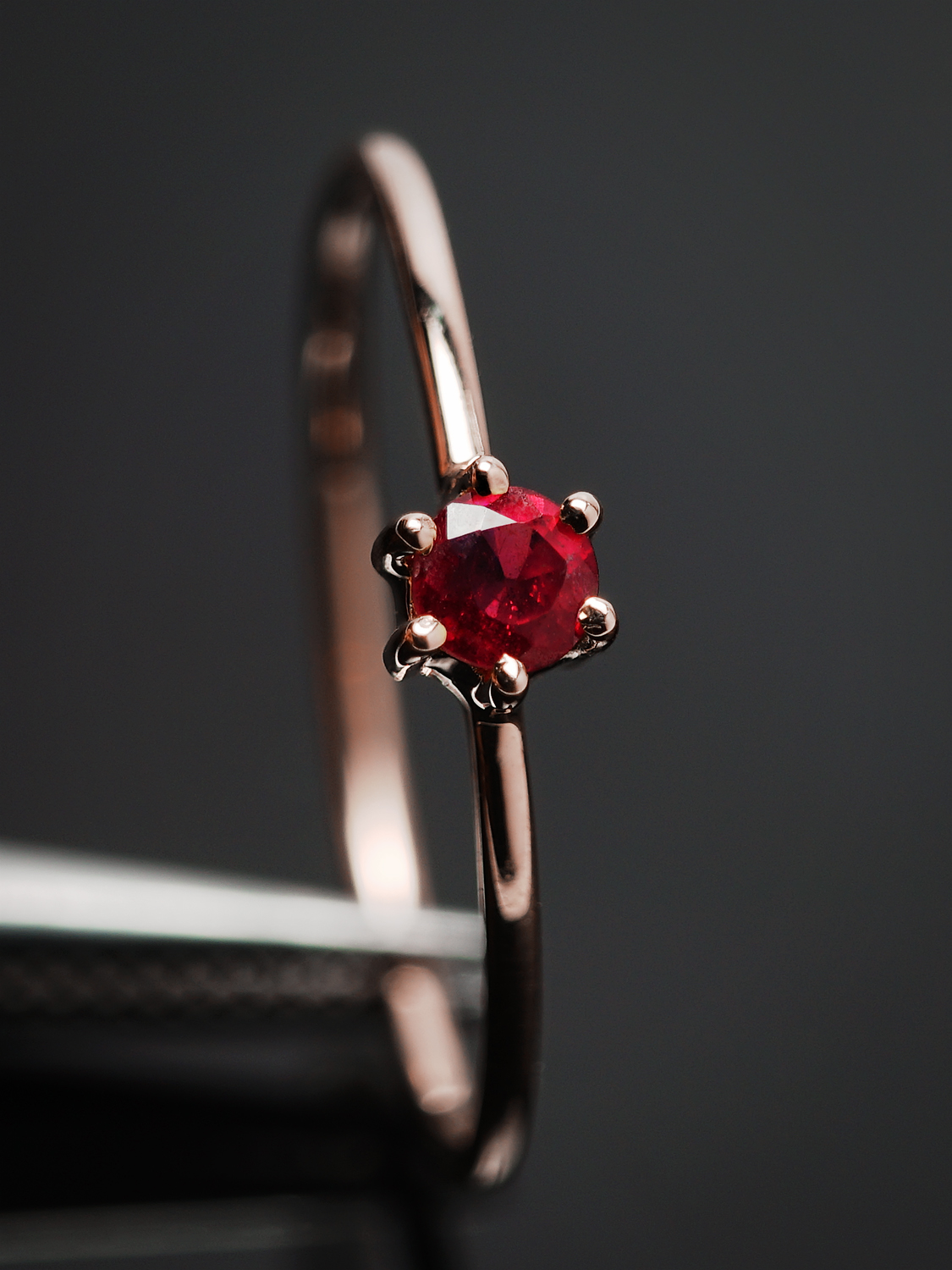 Elegant Ruby Solitaire Ring Close-up with Rose Gold Plating