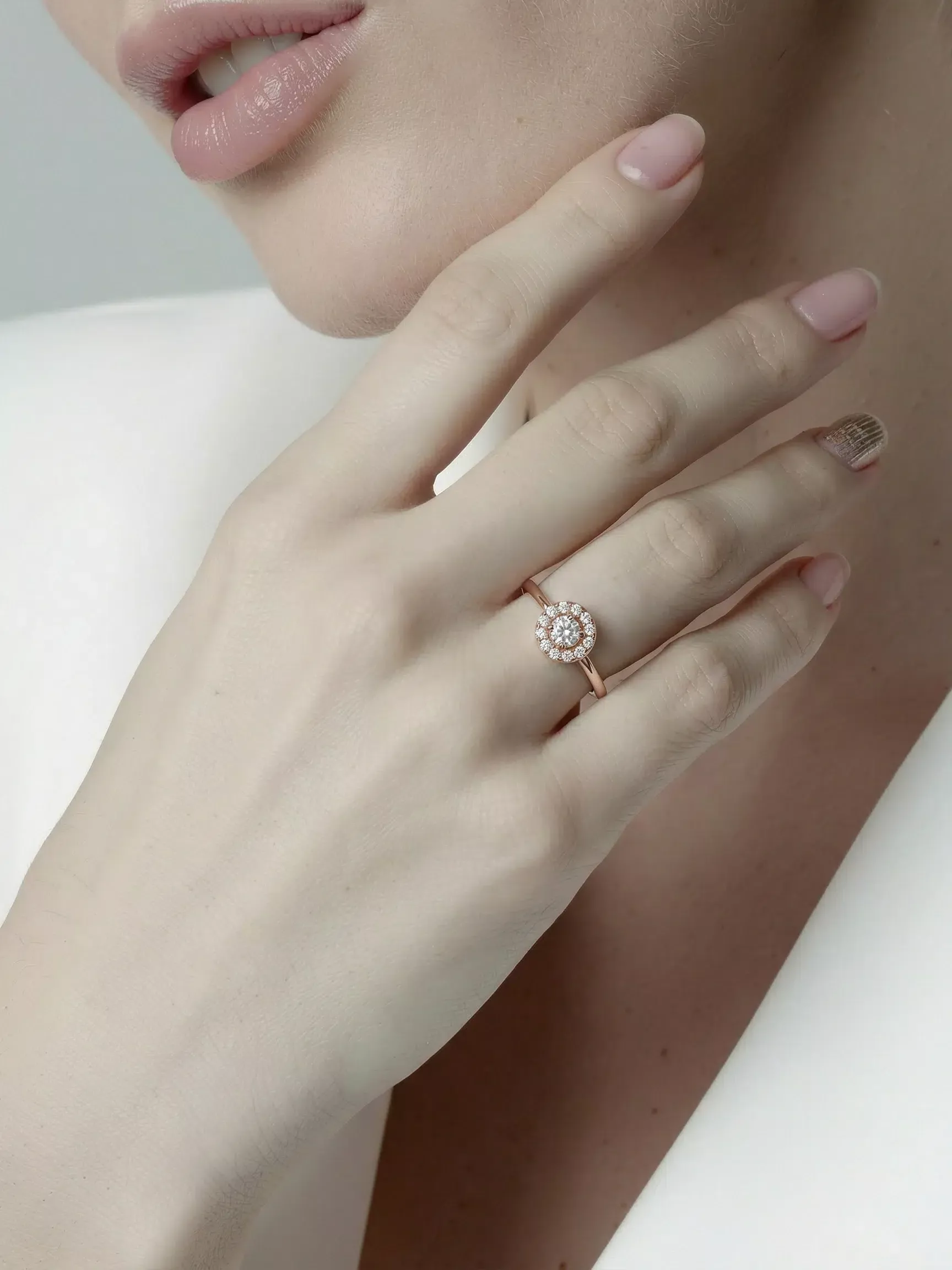 Woman wearing the Celeste Round Halo Moissanite Ring in Rose Gold Plated 925 Sterling Silver.